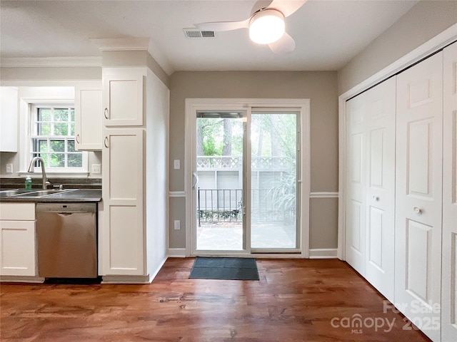 2619 Quailrush Rd, Charlotte, NC 28226 - kitchen with stainless steel dishwasher, a sink, dark countertops, white cabinets, and a ceiling fan