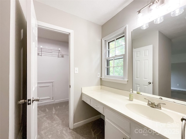 2619 Quailrush Rd, Charlotte, NC 28226 - bathroom with vanity, baseboards, and a walk in closet