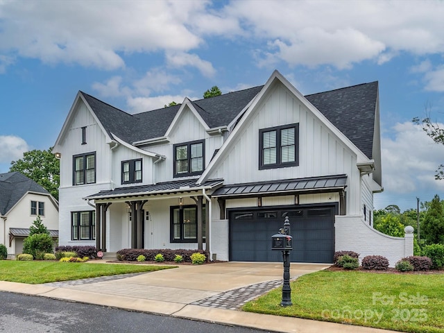 9426 Greyson Ridge Dr, Charlotte, NC 28277 - modern farmhouse style home with a standing seam roof, an attached garage, driveway, a shingled roof, and a front lawn