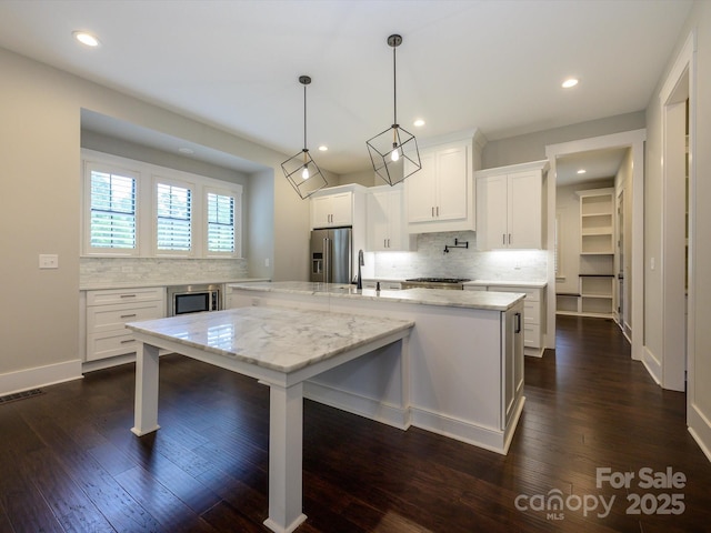 9426 Greyson Ridge Dr, Charlotte, NC 28277 - kitchen featuring high end refrigerator, backsplash, dark wood-style floors, white cabinets, and recessed lighting