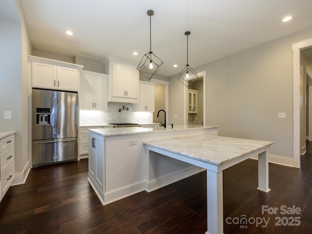 9426 Greyson Ridge Dr, Charlotte, NC 28277 - kitchen with high end fridge, a sink, a large island, backsplash, and recessed lighting