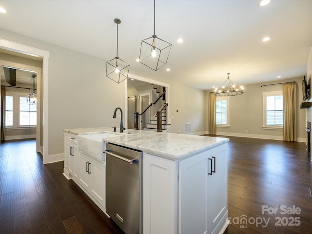 9426 Greyson Ridge Dr, Charlotte, NC 28277 - kitchen featuring stainless steel dishwasher, a sink, a chandelier, light stone counters, and white cabinetry