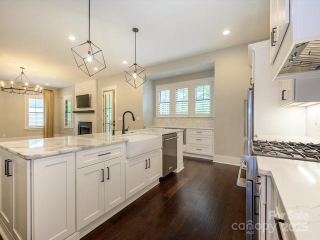 9426 Greyson Ridge Dr, Charlotte, NC 28277 - kitchen with stainless steel appliances, a sink, dark wood finished floors, recessed lighting, and white cabinets
