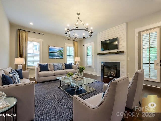 9426 Greyson Ridge Dr, Charlotte, NC 28277 - living area with a chandelier, a large fireplace, dark wood-style flooring, baseboards, and recessed lighting