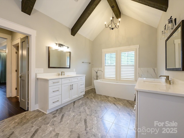 9426 Greyson Ridge Dr, Charlotte, NC 28277 - bathroom with two vanities, beamed ceiling, a freestanding bath, a chandelier, and high vaulted ceiling