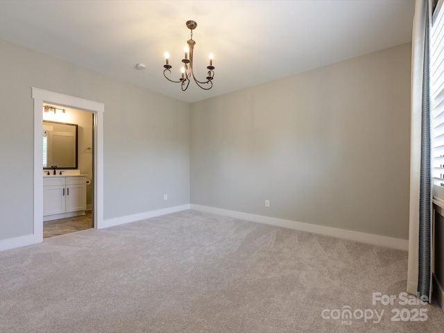 9426 Greyson Ridge Dr, Charlotte, NC 28277 - unfurnished room with a chandelier, light carpet, baseboards, and a sink
