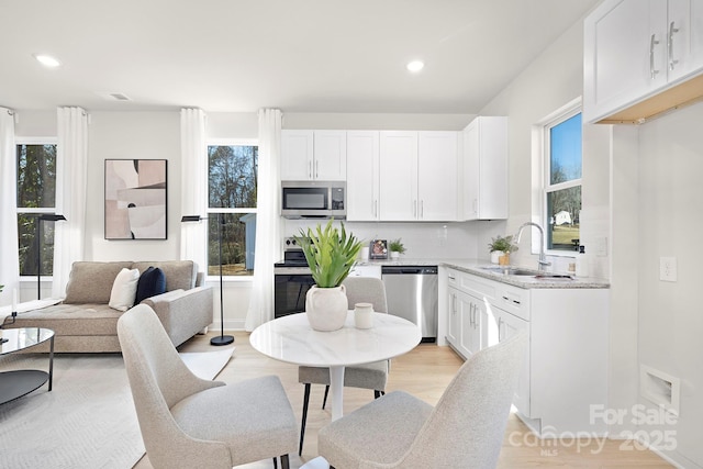 409 Blanton St, Shelby, NC 28150 - kitchen featuring stainless steel appliances, a sink, decorative backsplash, white cabinetry, and recessed lighting