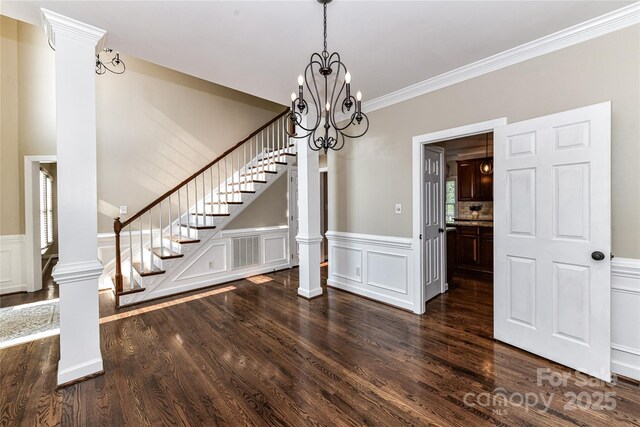 4637 Shannamara Dr, Matthews, NC 28104 - unfurnished dining area with stairs, wood finished floors, a wainscoted wall, a decorative wall, and a chandelier