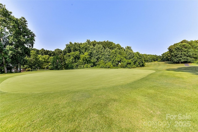 4637 Shannamara Dr, Matthews, NC 28104 - view of home's community featuring view of golf course, a lawn, and view of wooded area