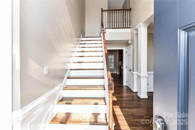 4637 Shannamara Dr, Matthews, NC 28104 - staircase featuring a towering ceiling, ornate columns, and wood finished floors