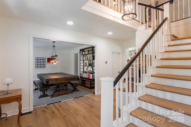 55 Foster Estate Dr, Asheville, NC 28806 - staircase with a chandelier, wood finished floors, baseboards, and recessed lighting