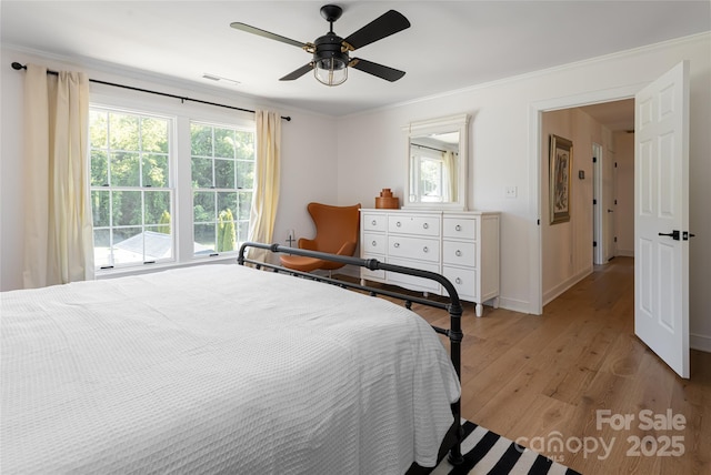 55 Foster Estate Dr, Asheville, NC 28806 - bedroom featuring light wood-style floors, multiple windows, ornamental molding, a ceiling fan, and baseboards