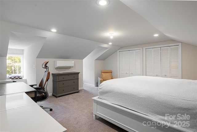 55 Foster Estate Dr, Asheville, NC 28806 - bedroom featuring vaulted ceiling, a wall mounted air conditioner, light colored carpet, recessed lighting, and two closets