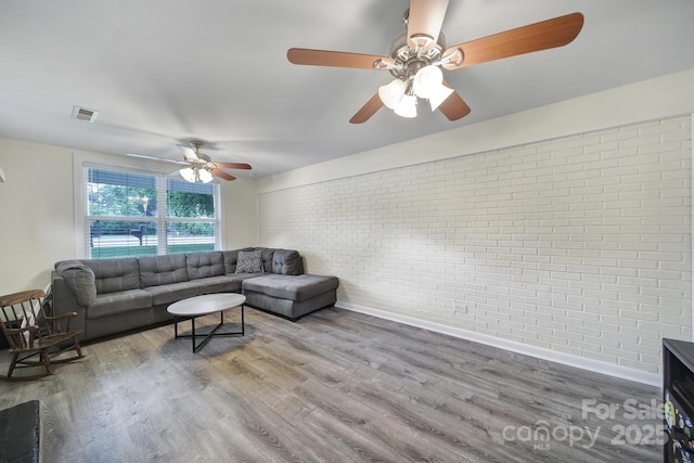 842 Cherry Rd S, Rock Hill, SC 29732 - living room featuring brick wall, a ceiling fan, and wood finished floors