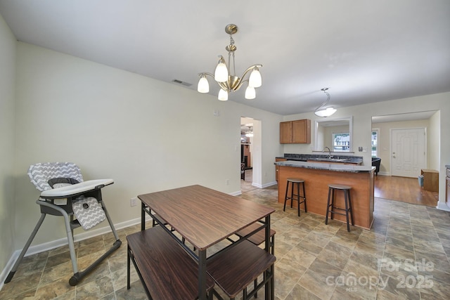 842 Cherry Rd S, Rock Hill, SC 29732 - dining area featuring light stone finish flooring and a chandelier