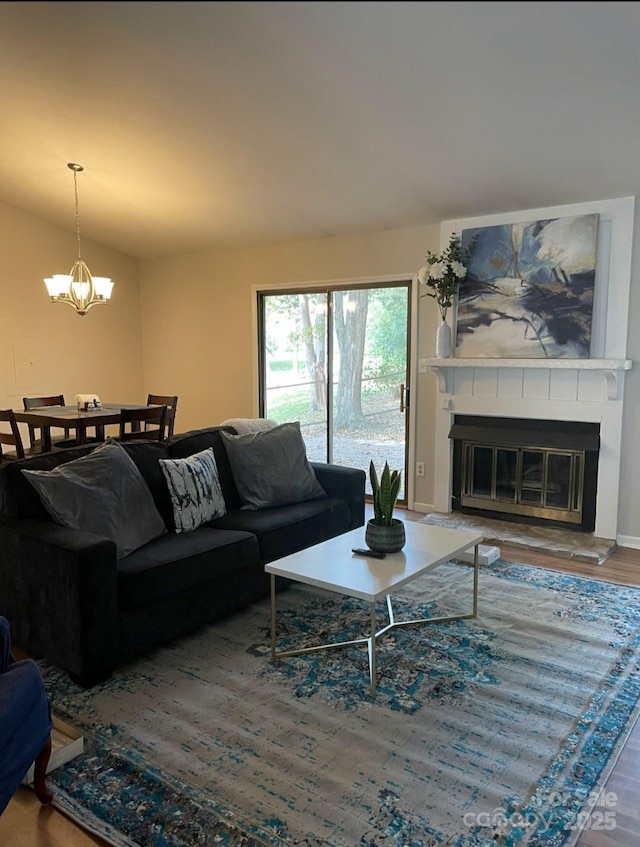 11421 Kingfisher Dr, Charlotte, NC 28226 - living room with a chandelier, a large fireplace, wood finished floors, and lofted ceiling