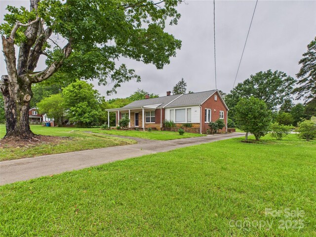 3055 16th St NE, Hickory, NC 28601 - single story home with brick siding, a chimney, a front yard, and asphalt driveway
