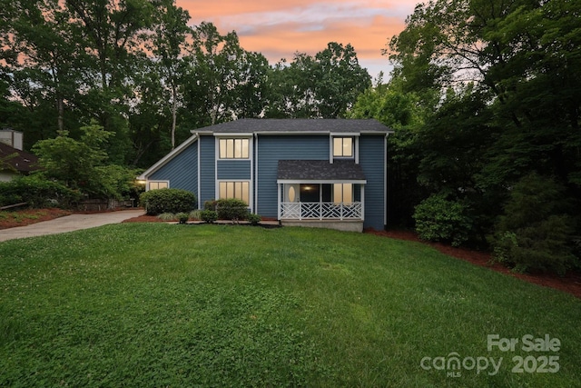 8338 Rittenhouse Cir, Charlotte, NC 28270 - traditional-style house with a lawn, covered porch, and view of wooded area