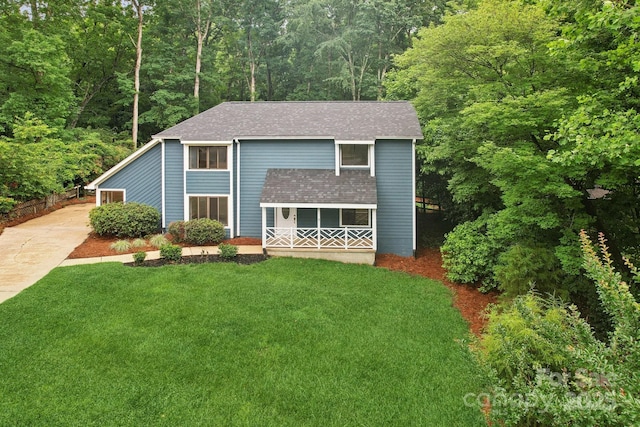 8338 Rittenhouse Cir, Charlotte, NC 28270 - view of front of house featuring roof with shingles, a front lawn, a porch, driveway, and a wooded view