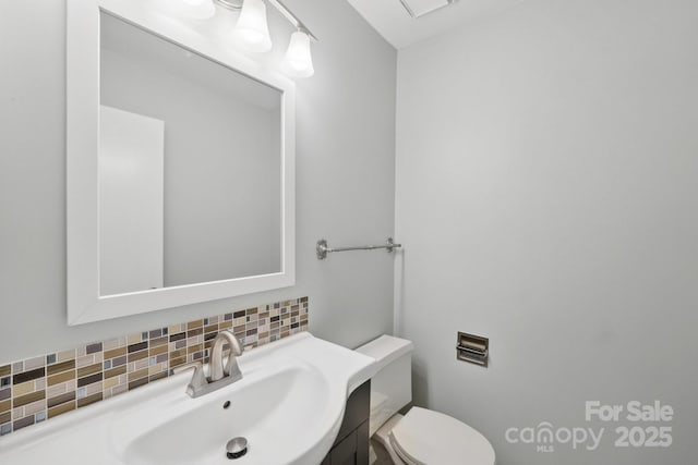 8338 Rittenhouse Cir, Charlotte, NC 28270 - half bathroom featuring decorative backsplash, vanity, and toilet