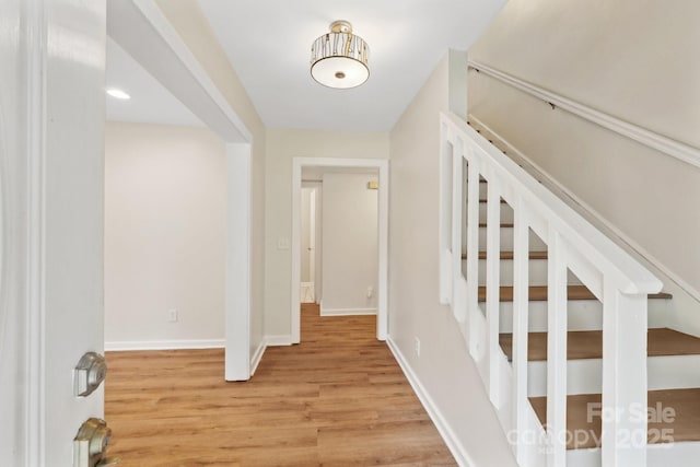 8338 Rittenhouse Cir, Charlotte, NC 28270 - foyer featuring light wood finished floors, stairs, and baseboards
