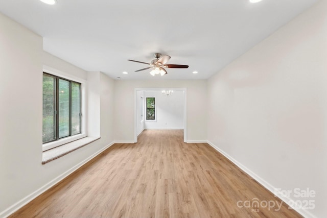 8338 Rittenhouse Cir, Charlotte, NC 28270 - empty room with healthy amount of natural light, wood finished floors, baseboards, recessed lighting, and a ceiling fan