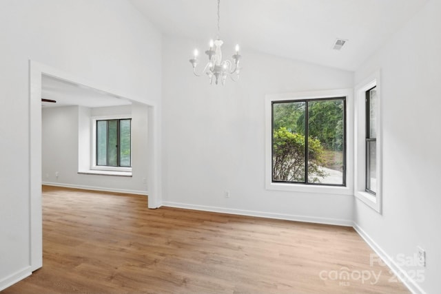 8338 Rittenhouse Cir, Charlotte, NC 28270 - unfurnished room with plenty of natural light, lofted ceiling, a chandelier, wood finished floors, and baseboards