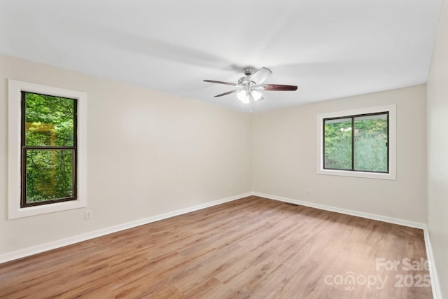 8338 Rittenhouse Cir, Charlotte, NC 28270 - spare room featuring healthy amount of natural light, light wood-style flooring, baseboards, and a ceiling fan