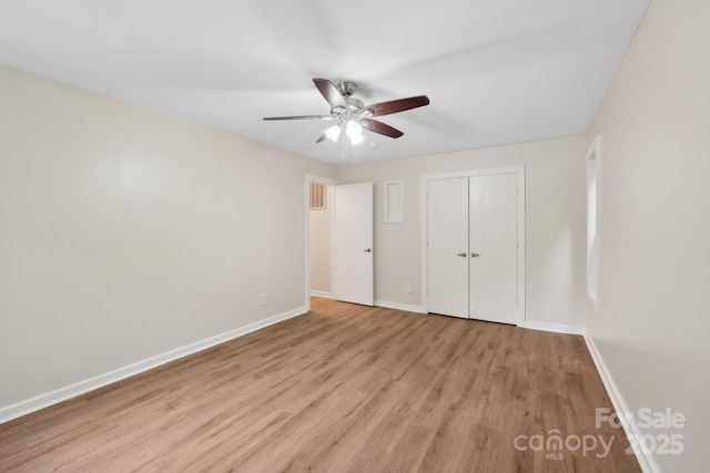 8338 Rittenhouse Cir, Charlotte, NC 28270 - unfurnished bedroom featuring light wood-type flooring, baseboards, a closet, and a ceiling fan