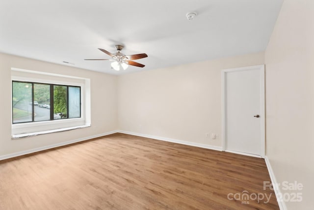 8338 Rittenhouse Cir, Charlotte, NC 28270 - spare room featuring wood finished floors, ceiling fan, baseboards, and a smoke detector