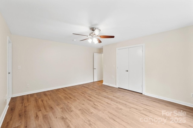 8338 Rittenhouse Cir, Charlotte, NC 28270 - unfurnished bedroom with light wood-style floors, baseboards, a closet, and a ceiling fan