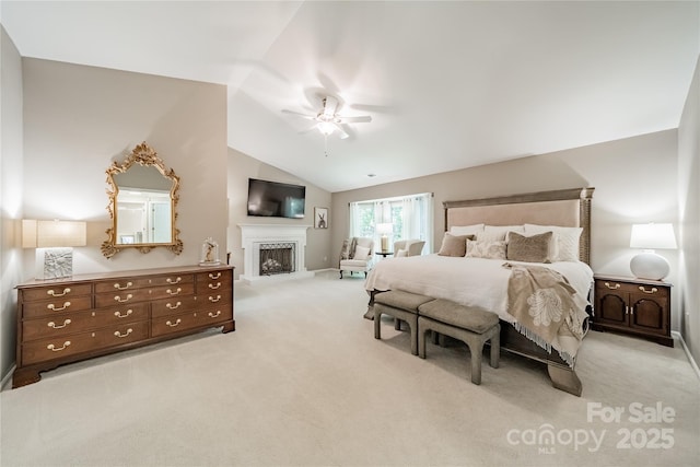 9920 White Cascade Dr, Charlotte, NC 28269 - carpeted bedroom featuring vaulted ceiling, a fireplace with raised hearth, ceiling fan, and baseboards