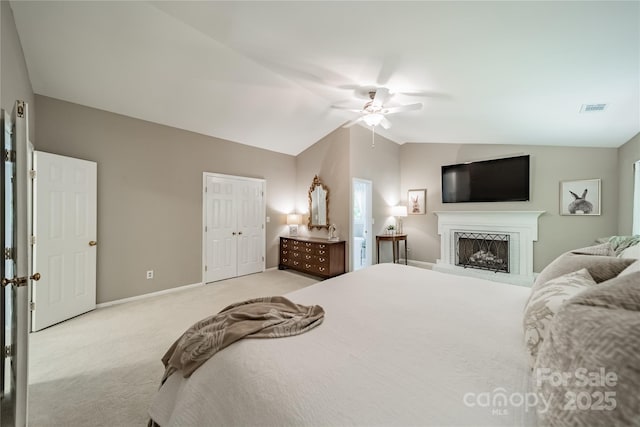 9920 White Cascade Dr, Charlotte, NC 28269 - bedroom featuring light colored carpet, vaulted ceiling, baseboards, ceiling fan, and a closet