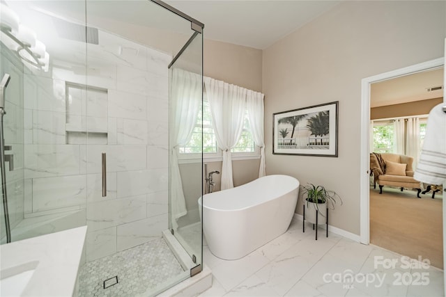 9920 White Cascade Dr, Charlotte, NC 28269 - full bath featuring marble finish floors, a soaking tub, and a stall shower