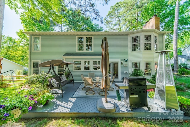 9920 White Cascade Dr, Charlotte, NC 28269 - rear view of property with a deck and a chimney