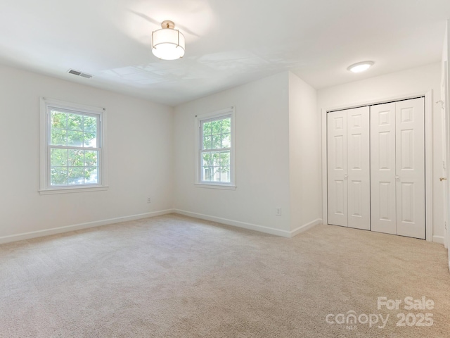 6817 Dumbarton Dr, Charlotte, NC 28210 - unfurnished bedroom with light carpet, baseboards, and a closet