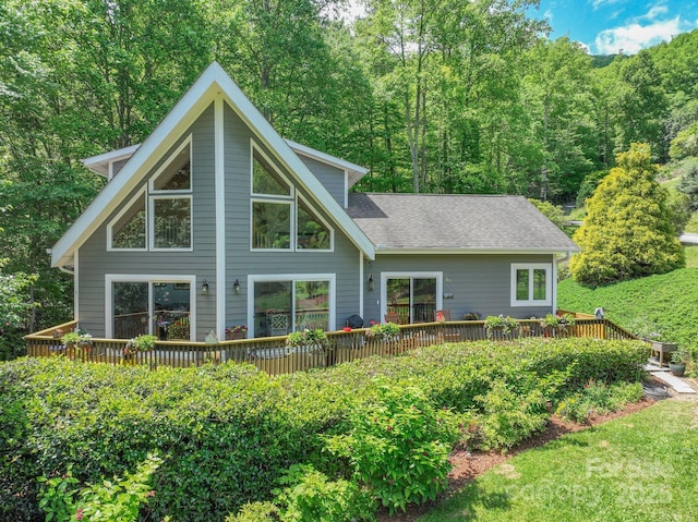 21 Kylie Grace Ln, Candler, NC 28715 - back of property featuring a deck, a shingled roof, and a forest view