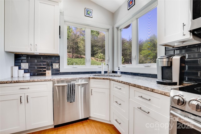 21 Kylie Grace Ln, Candler, NC 28715 - kitchen with appliances with stainless steel finishes, plenty of natural light, white cabinets, a sink, and lofted ceiling
