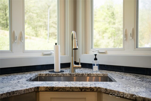 21 Kylie Grace Ln, Candler, NC 28715 - kitchen view of a sink, light stone counters, and white cabinets