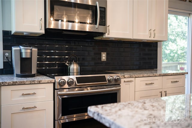 21 Kylie Grace Ln, Candler, NC 28715 - kitchen with appliances with stainless steel finishes, white cabinetry, backsplash, and light stone counters