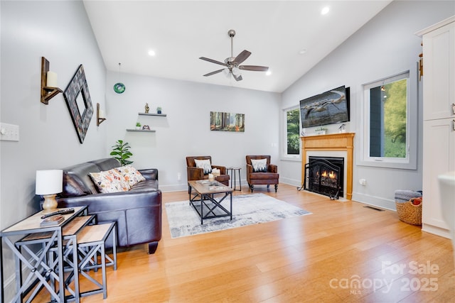 21 Kylie Grace Ln, Candler, NC 28715 - living area with vaulted ceiling, a ceiling fan, light wood-style flooring, a fireplace with flush hearth, and recessed lighting