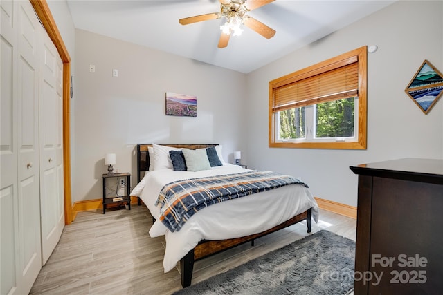 21 Kylie Grace Ln, Candler, NC 28715 - bedroom featuring baseboards, light wood finished floors, a closet, and a ceiling fan