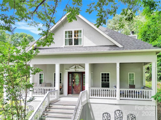 267 Ikerd Dr SE, Concord, NC 28025 - view of front of property featuring roof with shingles, a porch, and stucco siding