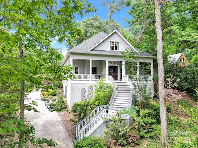 267 Ikerd Dr SE, Concord, NC 28025 - view of front of home featuring stairs, a porch, stucco siding, and roof with shingles