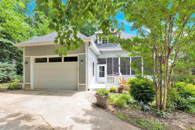 267 Ikerd Dr SE, Concord, NC 28025 - view of front of property with roof with shingles, concrete driveway, a garage, and a sunroom