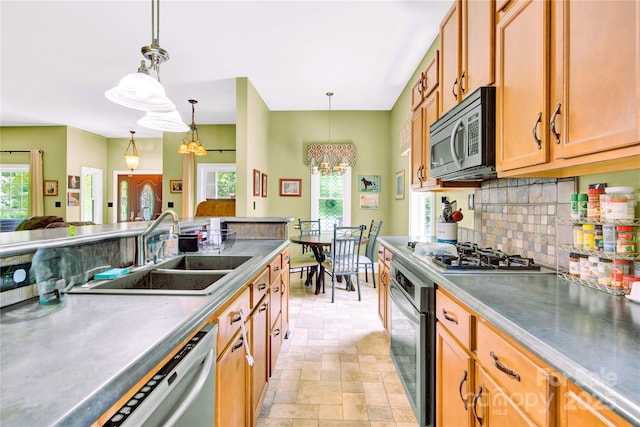 267 Ikerd Dr SE, Concord, NC 28025 - kitchen featuring stainless steel appliances, a chandelier, backsplash, and decorative light fixtures