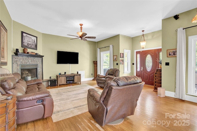 267 Ikerd Dr SE, Concord, NC 28025 - living area featuring wood finished floors, a fireplace with raised hearth, and a ceiling fan