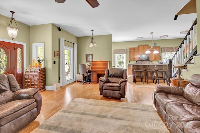 267 Ikerd Dr SE, Concord, NC 28025 - living room with plenty of natural light, light wood-style floors, a ceiling fan, and stairway