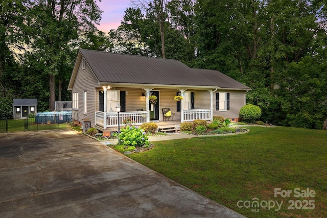 716 Mooresville Rd, Salisbury, NC 28144 - view of front of property with a porch, concrete driveway, a yard, metal roof, and crawl space