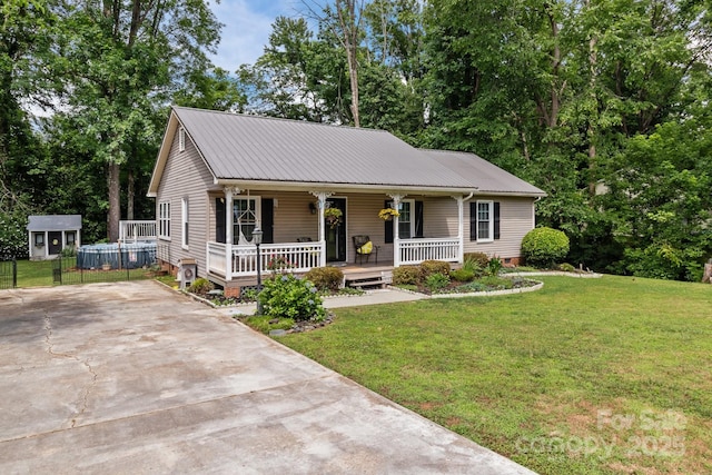 716 Mooresville Rd, Salisbury, NC 28144 - view of front facade featuring covered porch, a front yard, concrete driveway, and metal roof
